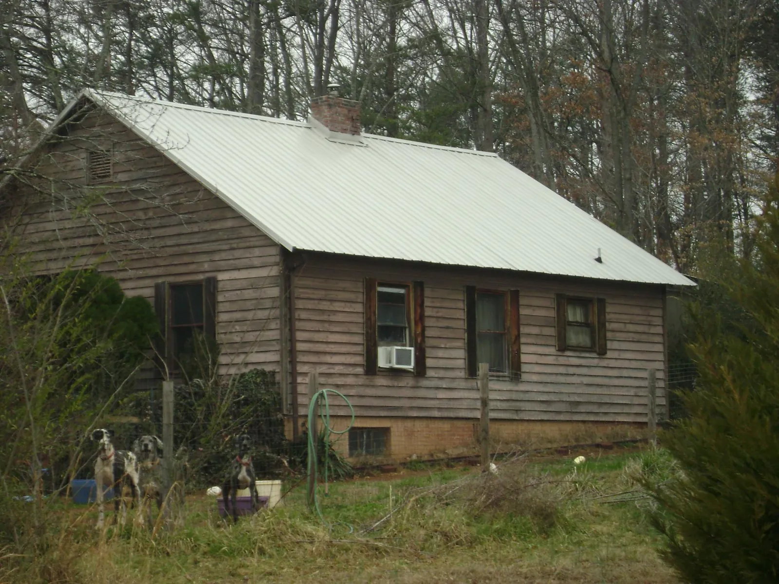 White metal roof on an old wood sided farmhouse, from a Metal Roof Installation job in Hitchcock